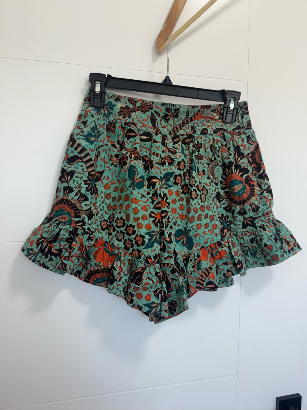 Ulla Johnson high-waist green patterned shorts with orange, black, and turquoise